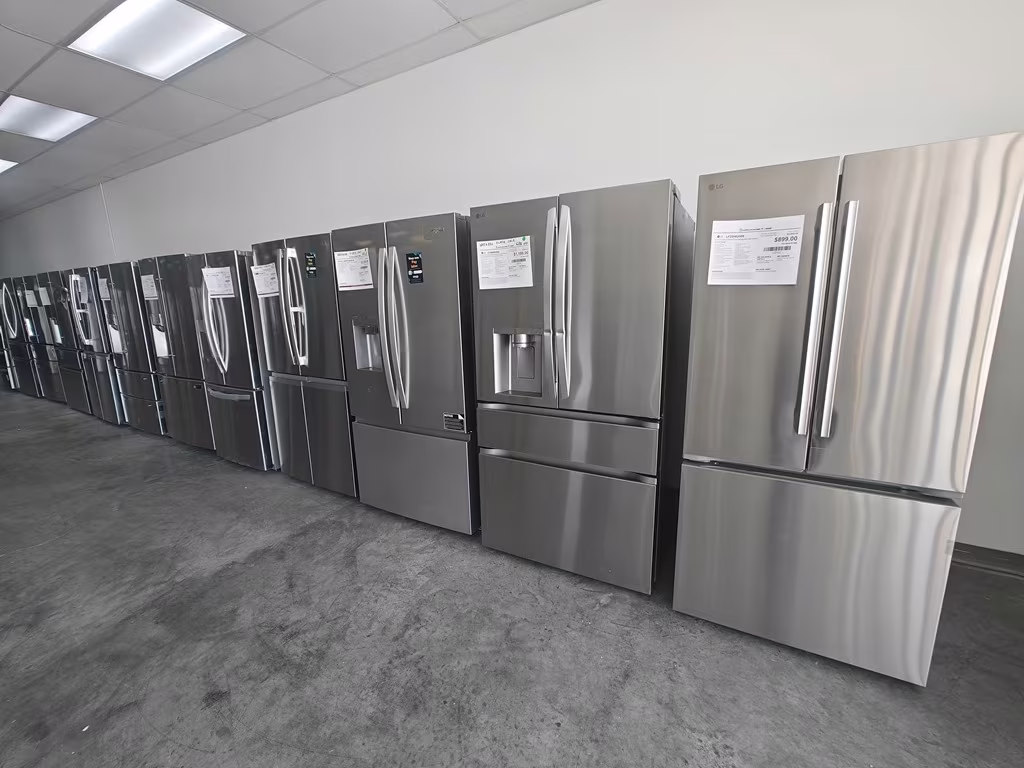 A long aisle of stainless French-door refrigerators