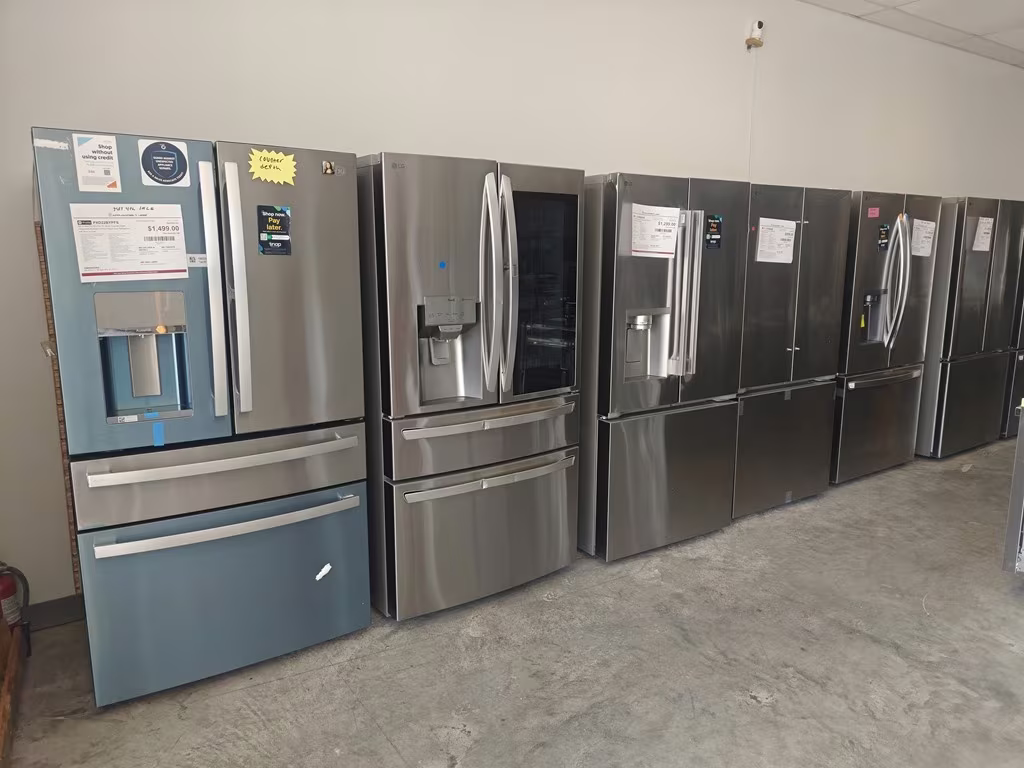 French-door refrigerators lined up along the wall