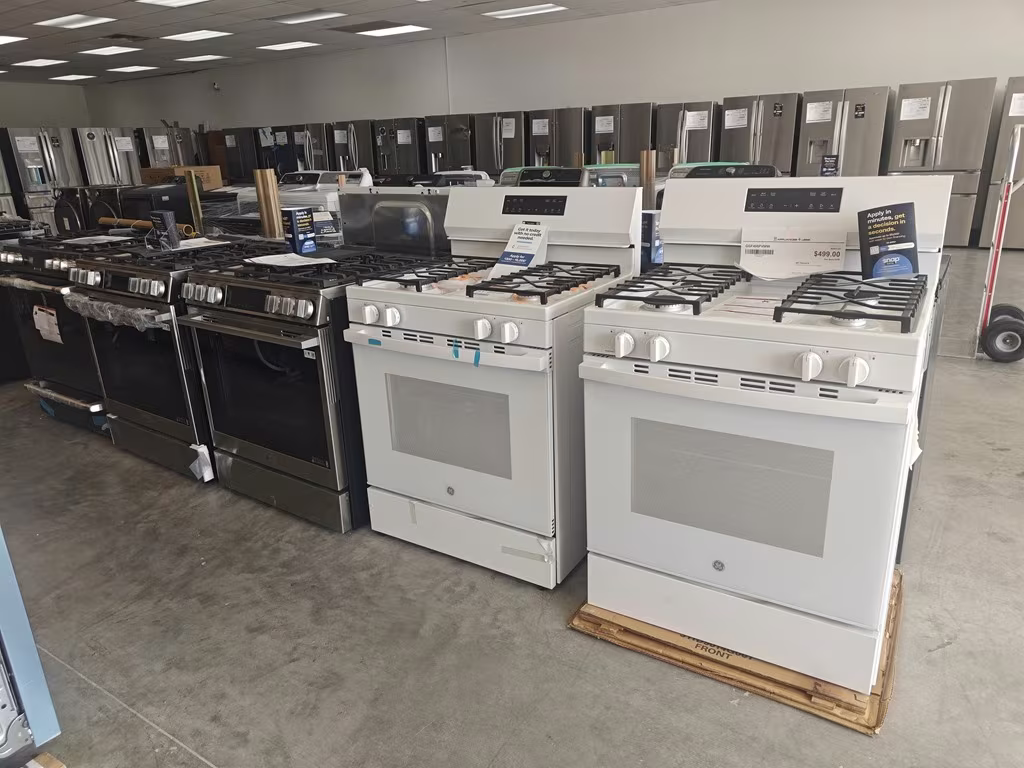 Gas ranges in stainless and white on the showroom floor